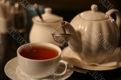 cup of tea and teaport on table in cafe