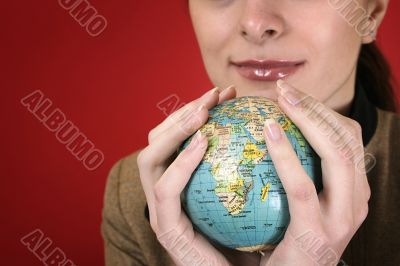 Globe in a girl`s hands