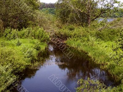 small river flows from lake