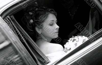 Bride in wedding car limousine