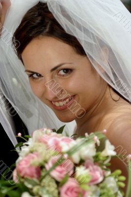 Smiling bride with bouquet
