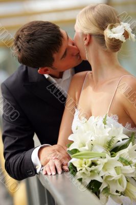 Bride and groom kissing in love