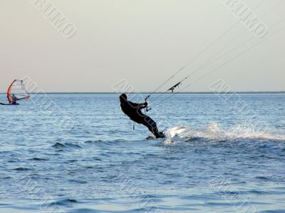 Silhouette of a kite-surf on waves of a gulf 1
