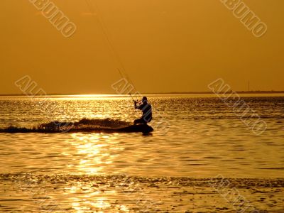 Silhouette of a kite-surf on waves of a gulf 1