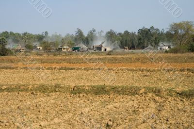 open field with view on stone industry,  india