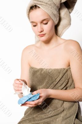 Young woman cleaning her skin
