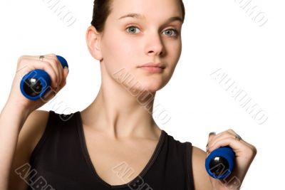 Young girl posing with weights