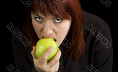 Girl eating delicious green apple