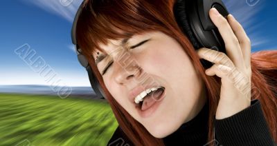 Cute redhead enjoying music