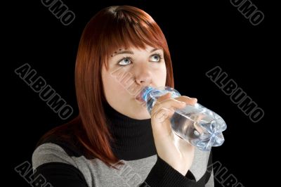 Redhead girl drinking water