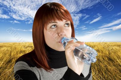 Redhead girl drinking water
