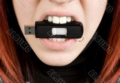 Girl biting an usb flash drive