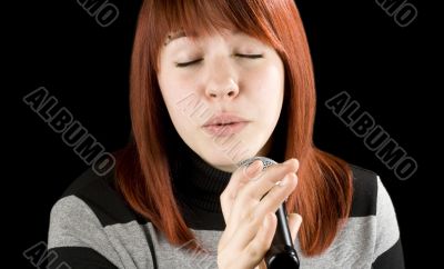 Girl singing karaoke on microphone