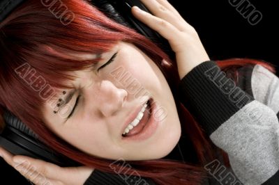 Girl holding headphones and singing