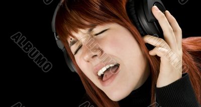 Cute redhead enjoying music