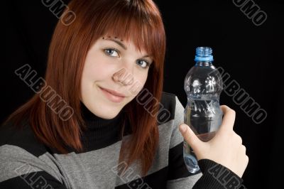 Redhead girl holding water bottle