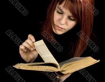 Girl turning book pages