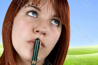 Cute girl with pen on her lips
