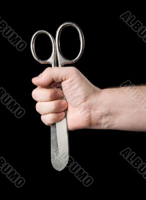 Scissors in a hand