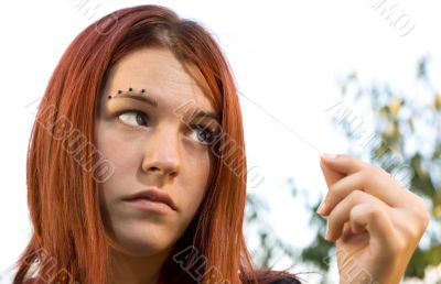 Pretty girl pulling hair and checking it