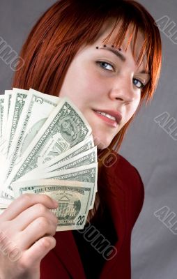 Sexy girl with a seductive look waving American dollars