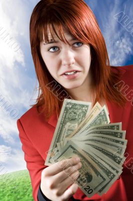 Surprised girl waving American dollars