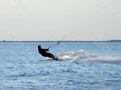 Silhouette of a kite-surf on waves of a gulf 2