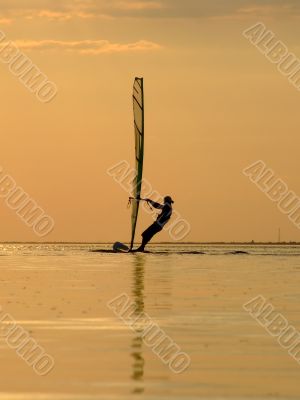 Silhouette of a wind-surfer on a sunset 1