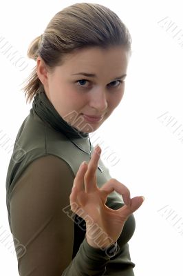 Young beautiful girl showing a sign ok on a white background.
