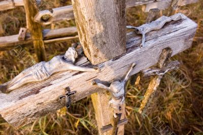 Jesus figures lying on an old cross