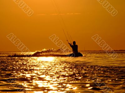 Silhouette of a kite-surf on a sunset 2