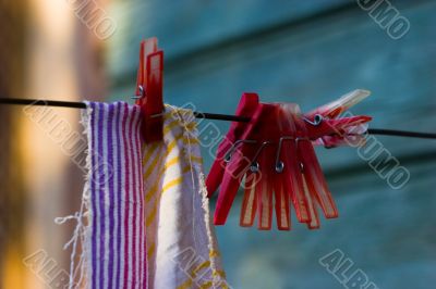 Red plastic clothespins and towel