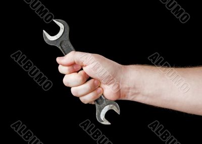 Wrench in hand.