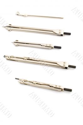 Set of compasses on white