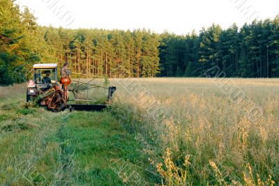 A man operates an old tractor