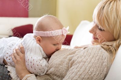Mother breast feeding her baby girl