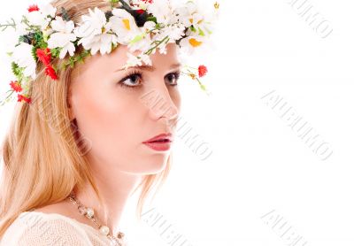 Pretty spring girl with wreath on head looking forward