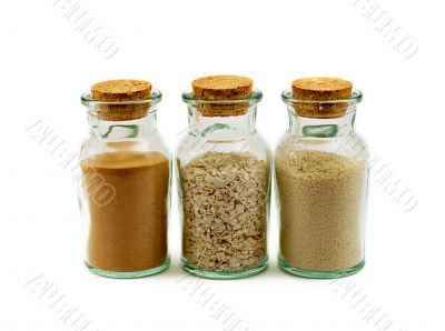 three glass bottles filled with sand