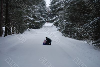 Sledding with a father and daughter