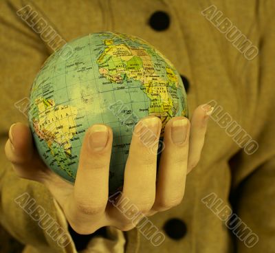 Globe in a girl`s hands