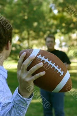 Two men throwing the football