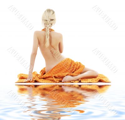 beautiful lady with orange towels on white sand