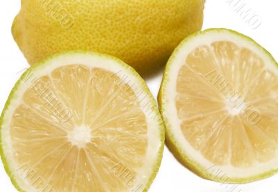 Closeup of three lemons on white