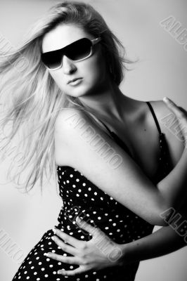 Girl with sunglasses looking down