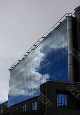 Dark clouds in a glass facade.