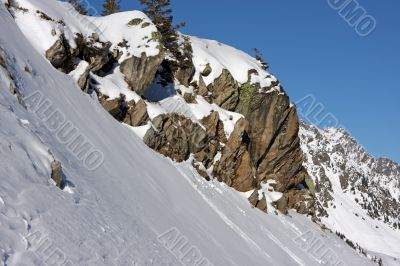 Boulders on snowy mountain