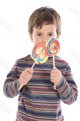 Child eating two lollipops