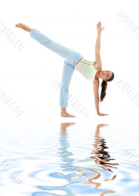 half moon pose on white sand