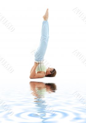 supported shoulderstand on white sand