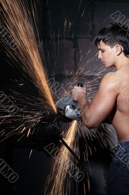 Worker cuts metal